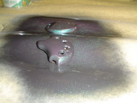 1995 Ford Taurus - Newly painted key fob components with a shimmering, iridescent finish are drying on protective paper.