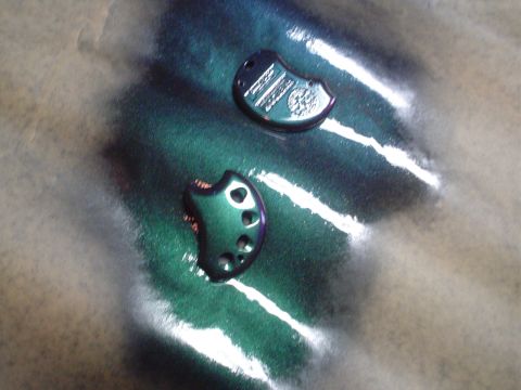 1995 Ford Taurus - Two key fobs, one with visible text and a circular emblem, are shown with a metallic green finish.