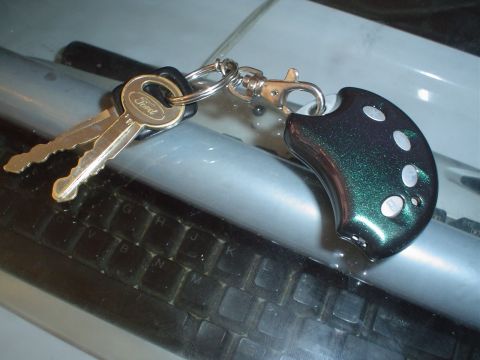 1995 Ford Taurus - Ford keys and a keyfob are resting on a surface, possibly a car's dashboard.