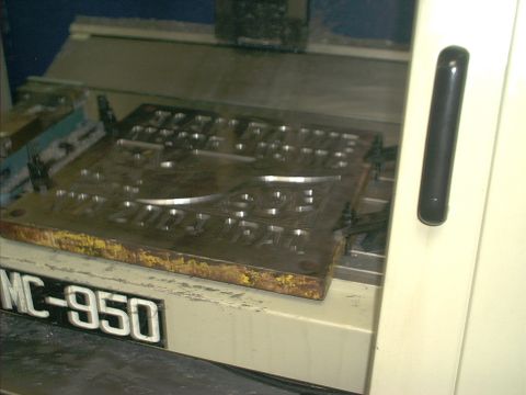 1966 Ford Bronco - A metal stamping die, possibly for creating vehicle emblems, is shown mounted on a machine labeled MC-950.
