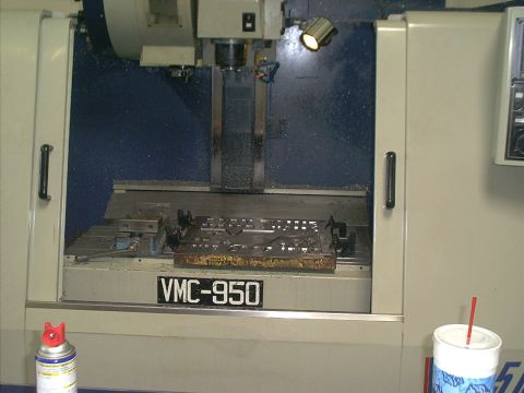 1966 Ford Bronco - A VMC-950 milling machine is shown with a workpiece clamped to its table.