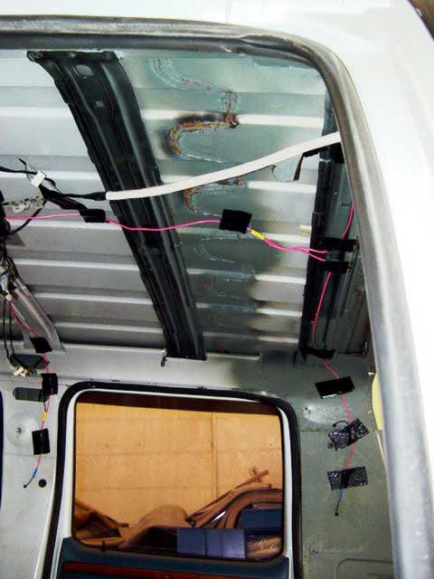 1994 Ford C-350 (Centurion Conversions) - The interior of a van shows exposed wiring and structural elements, indicating it is undergoing modification or repair.