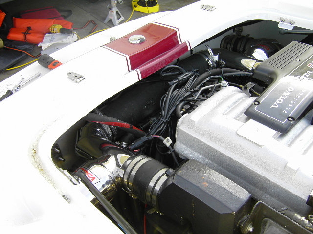 White boat engine bay with gray Volvo Penta marine engine and black wiring