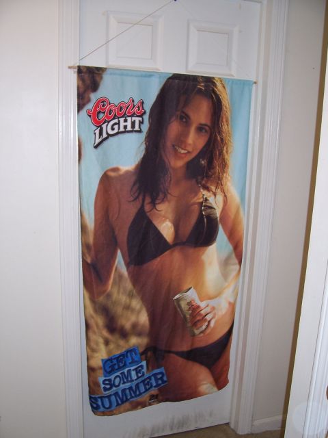 1995 Ford Bronco - A fabric Coors Light beach-towel banner reading 'GET SOME SUMMER' hangs from a rod over a white paneled interior door in a room with white…