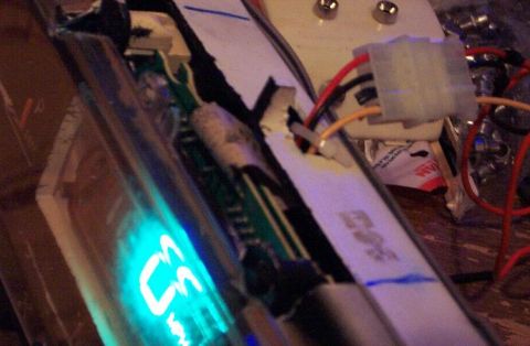 1985 Ford Crown Victoria LTD - This is a close-up of an electronic component with visible wiring and a glowing blue display.