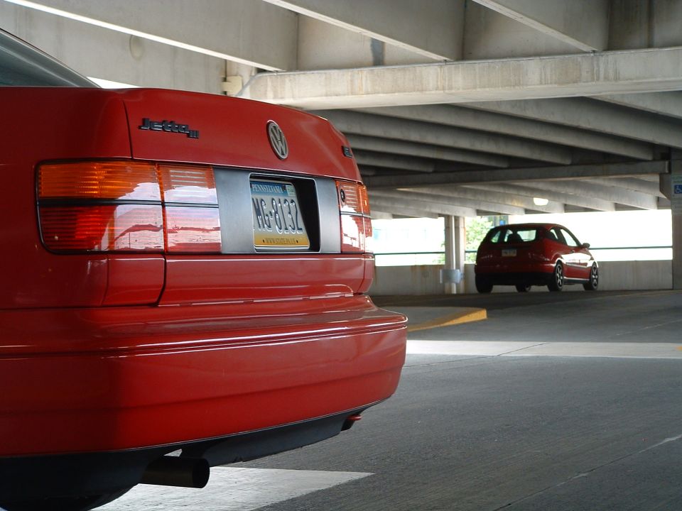 Rear view of red 1994 Volkswagen Jetta, another red car in background