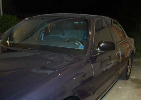1998 Ford Crown Victoria - This 1998 Ford Crown Victoria is shown from a 3/4 front angle, highlighting its dark purple paint.