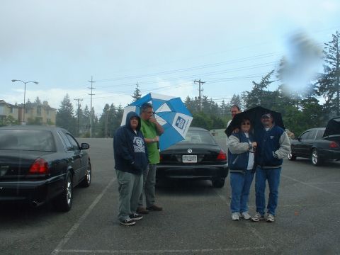1999 Ford Crown Victoria - 45 minutes later, another set of rain clouds come in. Linda and BJ keeping each other dry.