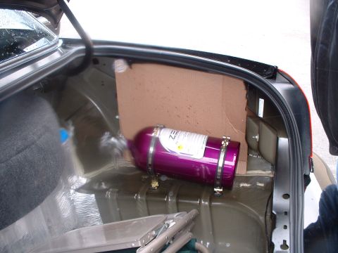 1999 Ford Crown Victoria - The trunk of a car contains a purple nitrous oxide tank and appears to be modified.