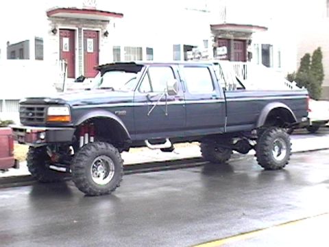 1979 Ford Bronco - This lifted crew cab pickup truck appears to be from the early 1990s, not a 1979 Bronco.