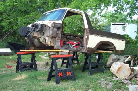 1979 Ford Bronco - The body of a 1979 Ford Bronco sits disassembled on sawhorses, awaiting restoration.