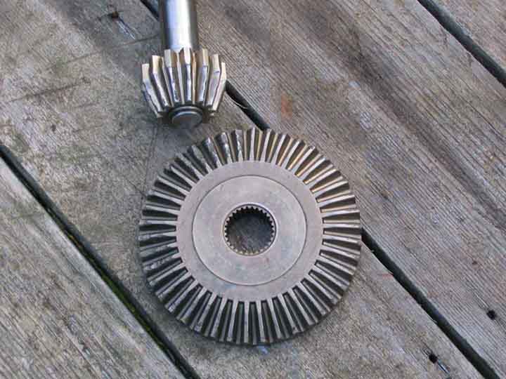 Used differential ring gear and pinion set laid on weathered deck boards