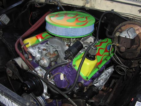 1979 Ford Bronco - Customized engine compartment with vibrant flame graphics on the valve covers and air filter housing.