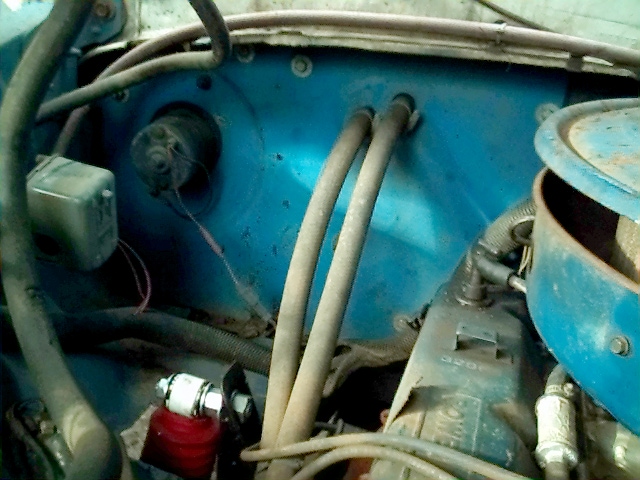 Blue engine bay firewall with heater hoses, relay box and blue round air cleaner