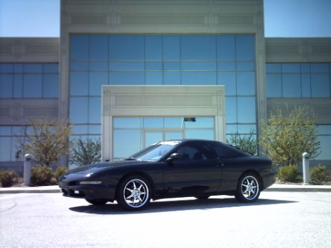 1995 Ford Probe - 1995 Ford Probe parked in front of a building, with Supermotors.net logo at the bottom.