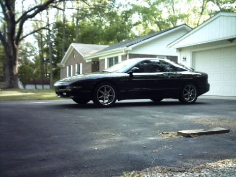 1995 Ford Probe - This black 1995 Ford Probe is parked in front of a suburban garage.