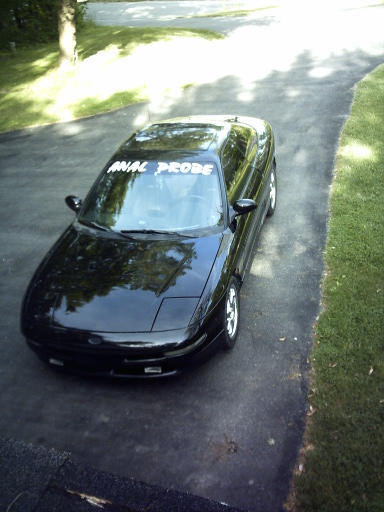1995 Ford Probe - 1995 Ford Probe with a custom windshield banner is parked on a driveway.