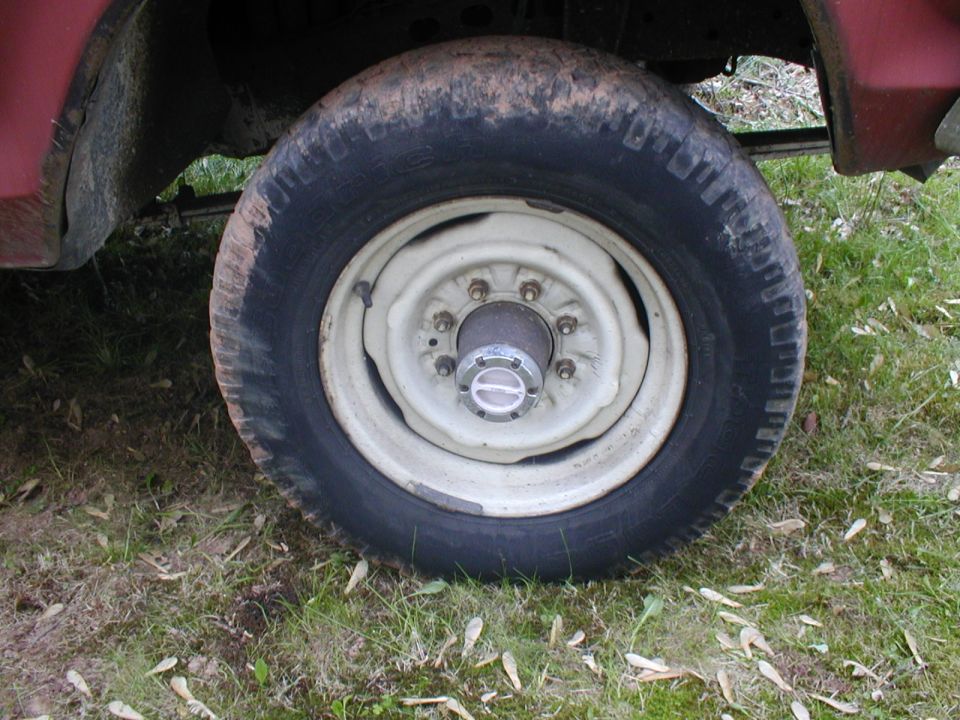 1979 Ford Bronco wheel with white rim and chrome hubcap