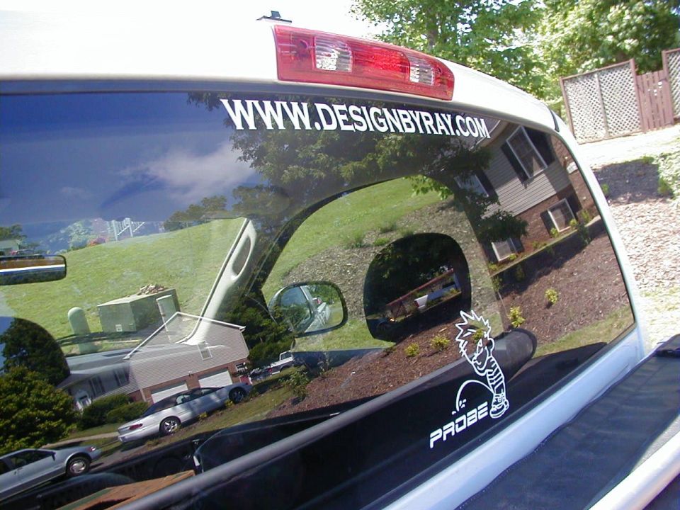 White sticker with 'PROBE' text and cartoon character on a vehicle window