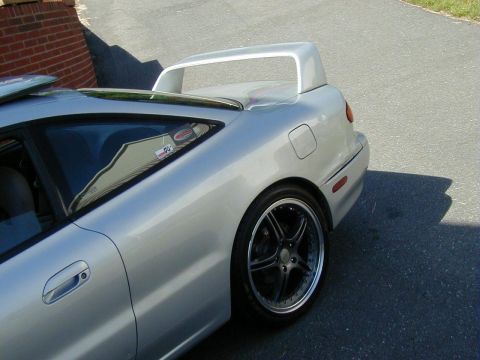 1994 Ford Probe - This 1994 Ford Probe coupe features a prominent rear spoiler and custom wheels, viewed from its rear three-quarter angle.