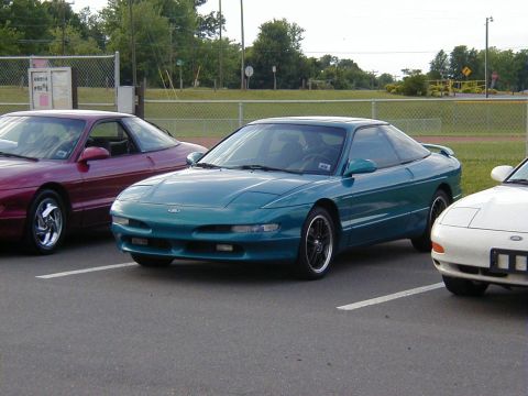 1994 Ford Probe - Three Ford Probes are parked in a lot, with the teal one in the foreground.