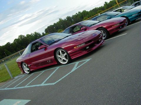 1994 Ford Probe - Several Ford Probes are parked in a lot, with the closest one being a maroon GT model.