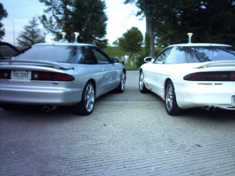 1995 Ford Probe - Two 1995 Ford Probes are seen from the rear, parked next to each other on a paved surface.