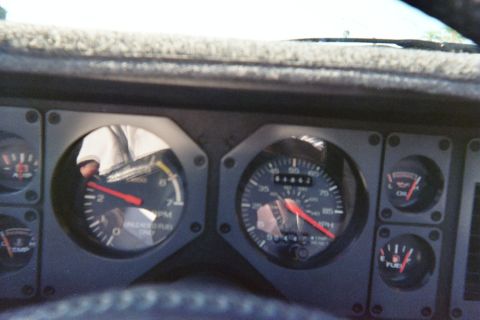 1985 Ford Mustang - The interior view of a 1985 Ford Mustang shows the dashboard gauges, including the tachometer and speedometer.