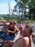 1985 Toyota 4Runner - A group of people enjoy a sunny day outdoors, with a backdrop of trees and rolling hills.