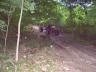 1985 Toyota 4Runner - Several ATVs are parked on a dirt path surrounded by trees.