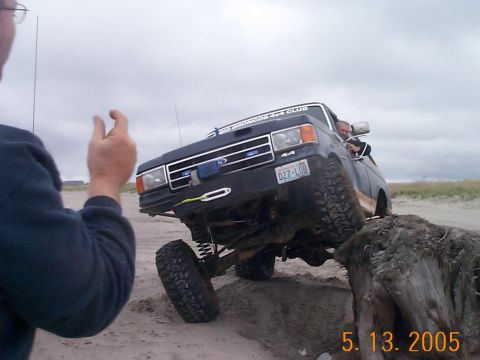 1983 Ford Bronco - This 1983 Ford Bronco is navigating a sandy obstacle course, as indicated by the '4x4 Club' sticker on its grille.