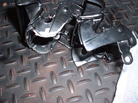1978 Ford Mustang II - Close-up view of hood latch mechanisms mounted on textured flooring.