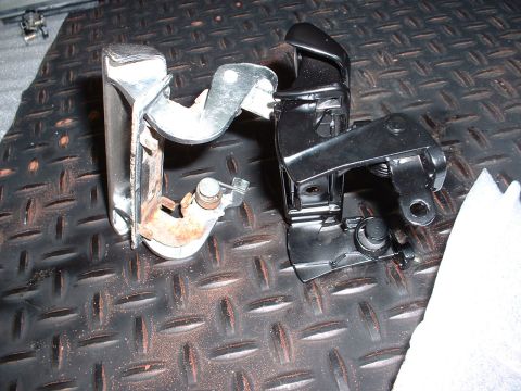1978 Ford Mustang II - Comparison of a worn hood latch mechanism with a new replacement part.