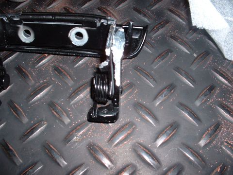 1978 Ford Mustang II - A close-up view of a car door handle mechanism, showing its internal components and mounting points.