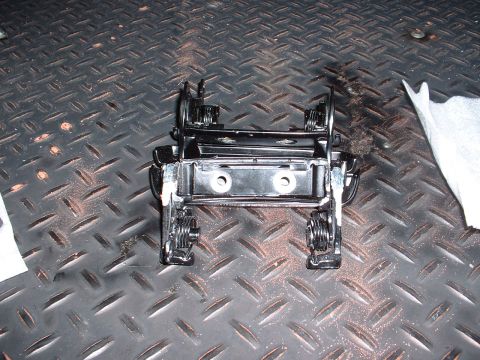 1978 Ford Mustang II - Close-up of a black metal automotive part with visible springs and mounting points.