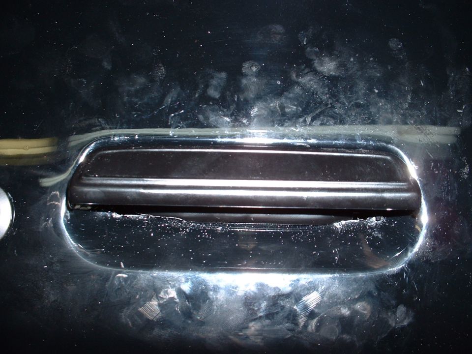 Black car door handle with chrome trim