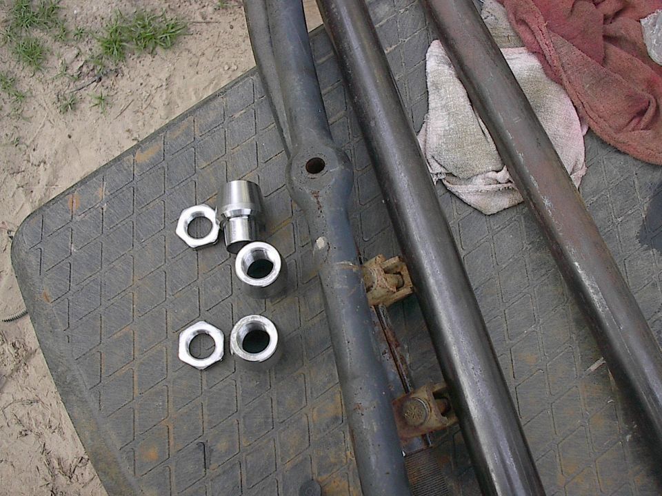 Tie rod ends and nuts on a textured surface