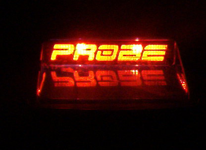 1995 Ford Probe - Close-up of an illuminated red "PROBE" emblem, likely from a car.