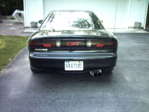 1995 Ford Probe - Rear view of a black car with a GT badge and dual exhaust pipes.