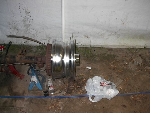 1997 Dodge 1500 - Rear axle assembly and chrome wheel removed from vehicle, possibly for repair or upgrade.