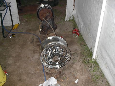 1997 Dodge 1500 - A rear axle assembly with shiny chrome wheels is shown on a concrete surface.