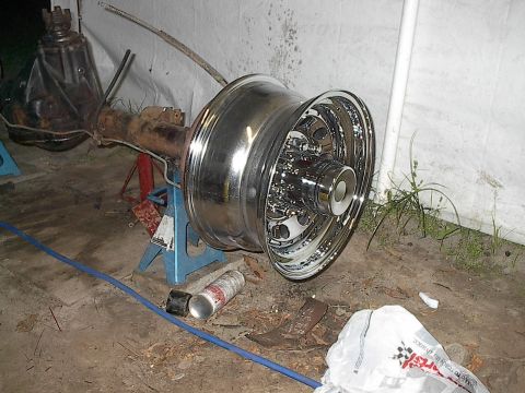 1997 Dodge 1500 - A rear axle assembly is shown with a large, polished chrome dually wheel mounted. The assembly is supported by jack stands.