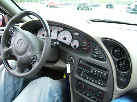 1998 Ford Taurus - Interior view of a car, likely a Pontiac Grand Am, showing the dashboard and steering wheel.