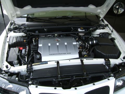 1998 Ford Taurus - The engine bay of a white car displays a Northstar V8 engine cover and a SuperMotors.net watermark.