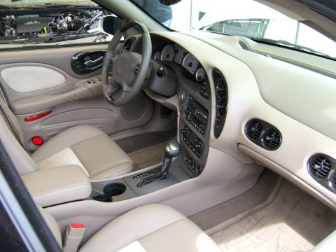 1998 Ford Taurus - Interior view of a car, highlighting the dashboard and seating area. The engine is visible in the background.