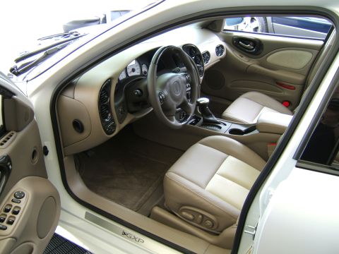 1998 Ford Taurus - Interior view of a car, showing the dashboard, seats, and door panel. The GXP emblem is visible on the door sill.