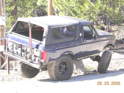 1994 Ford Bronco - Modified Ford Bronco with a soft top and off-road equipment, photographed outdoors.