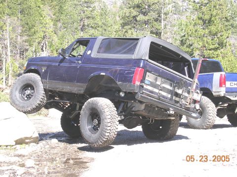 1994 Ford Bronco - This modified Ford Bronco is navigating an obstacle course with a second truck in the background.