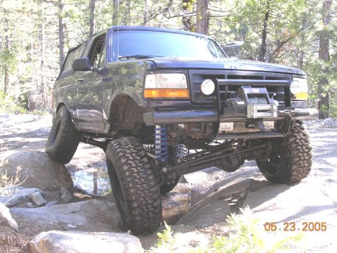 1994 Ford Bronco - This 1994 Ford Bronco is shown off-roading over rocks with a winch mounted on the front bumper.