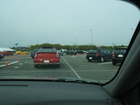 1998 Ford Taurus - A parking lot scene shows multiple vehicles, including a red car in the foreground.